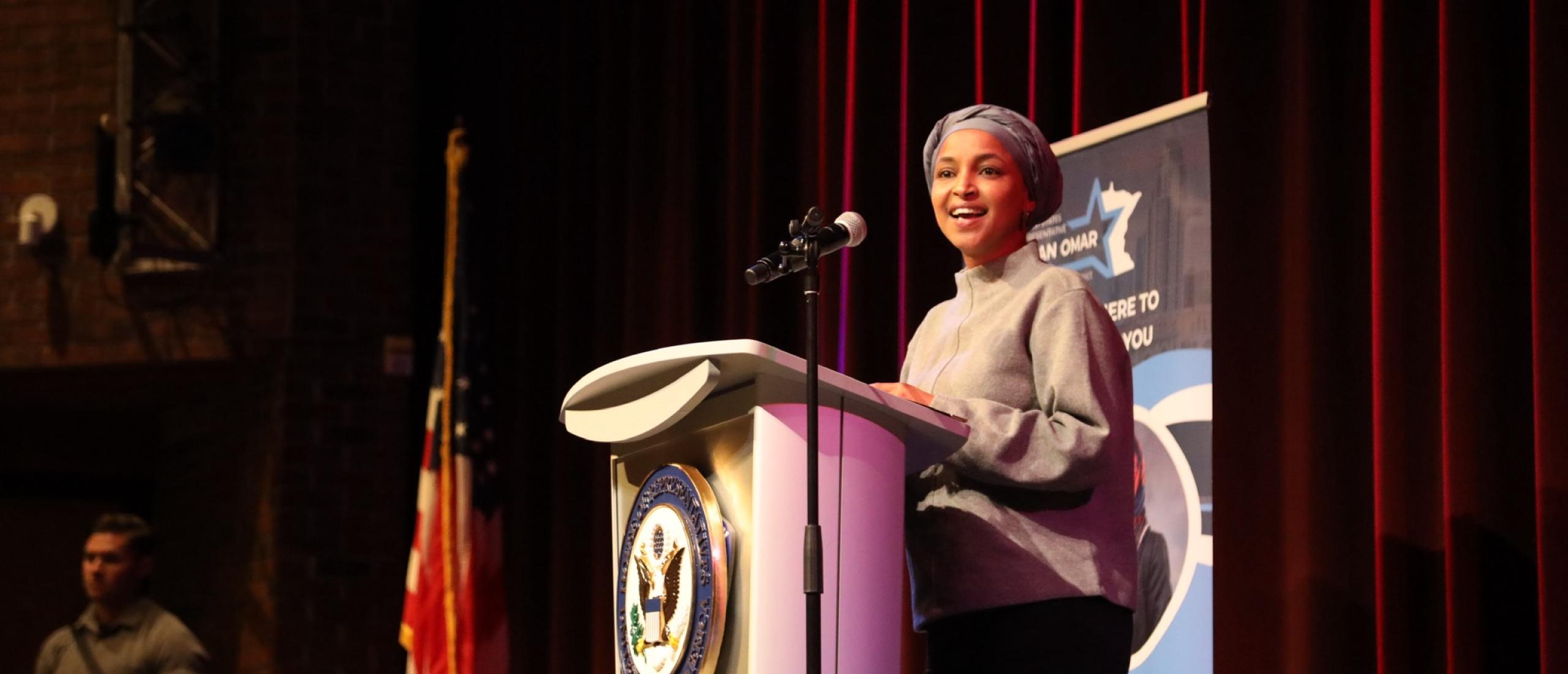 Rep. Omar speaks on stage at her March 2026 Town Hall in Spring Lake Park